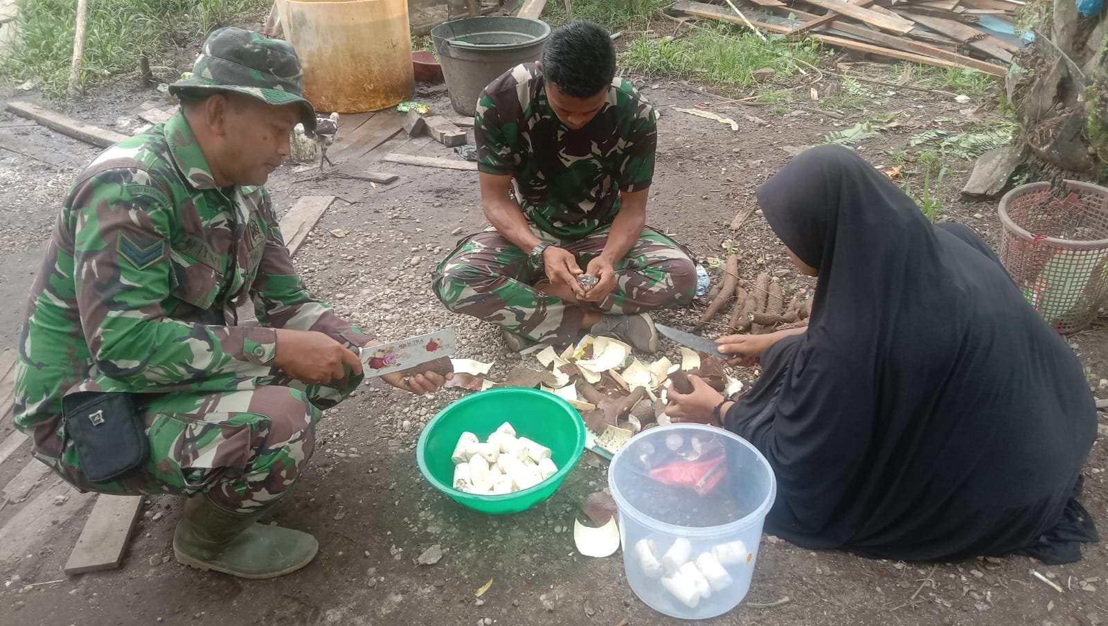 Satgas TNI Bantu Ibu Ariama Mengupas Ubi di Lokasi TMMD ke 114